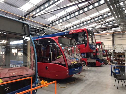A row of buses inside a depot