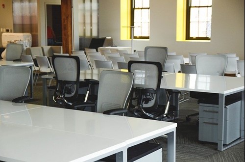 An empty office with desks and chairs