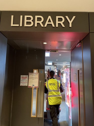 A Business Moves Group employee in the entrance of the University of Winchester library