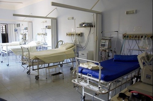 A row of empty beds in a hospital ward