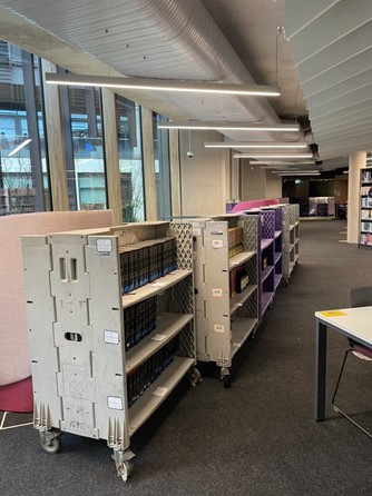 Trolleys with books in the University of Winchester library