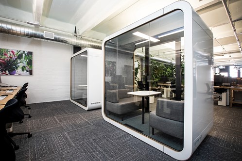 Two soundproof booths in an open plan office